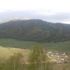 Демино и заснеженная вершина горы Плешивой в мае